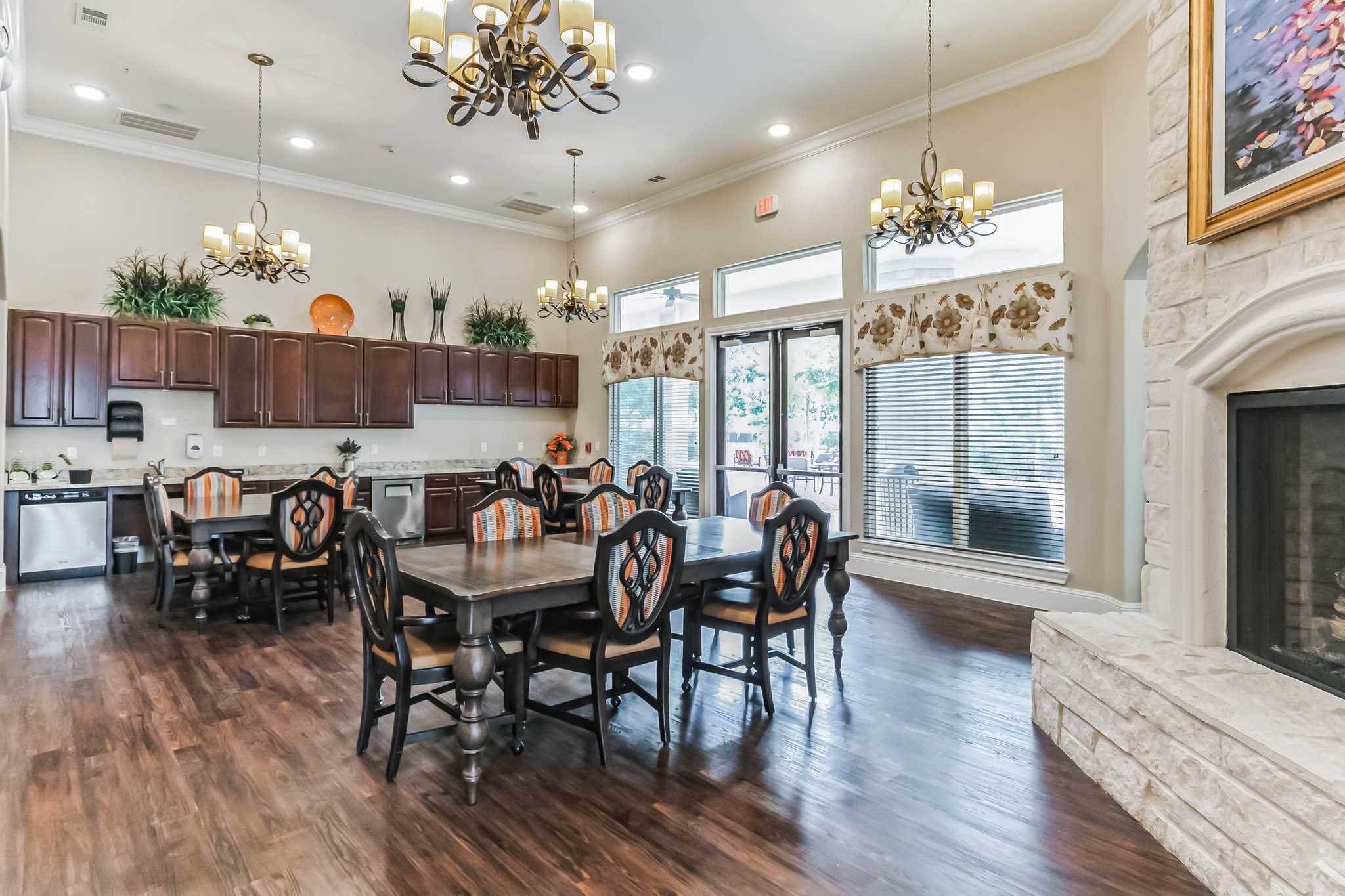Interior image of the shared kitchen and smaller dining room at Woodhaven Village, a senior living community near The Woodlands, TX.