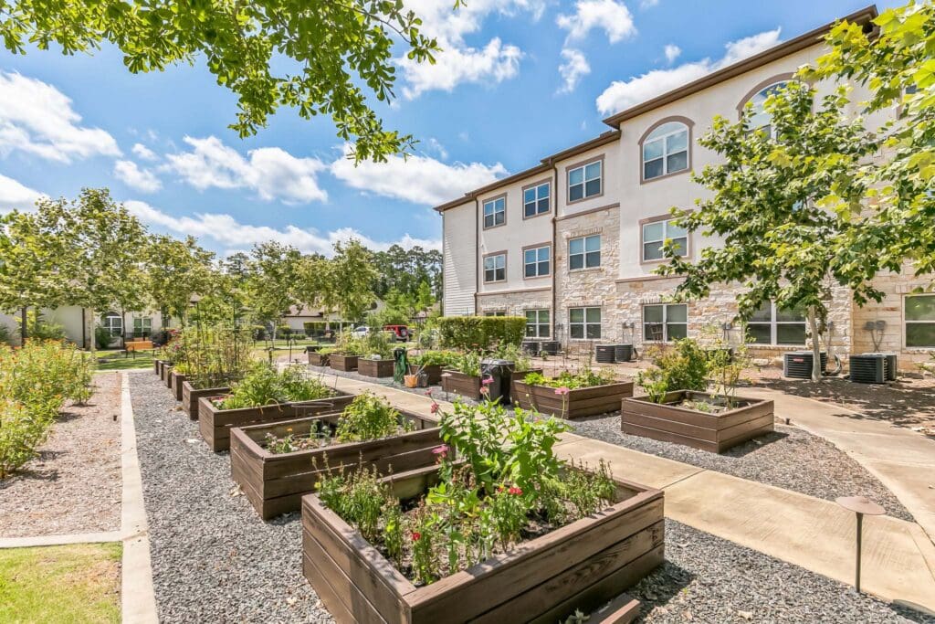 Exterior image of Woodhaven Village's community garden beds.